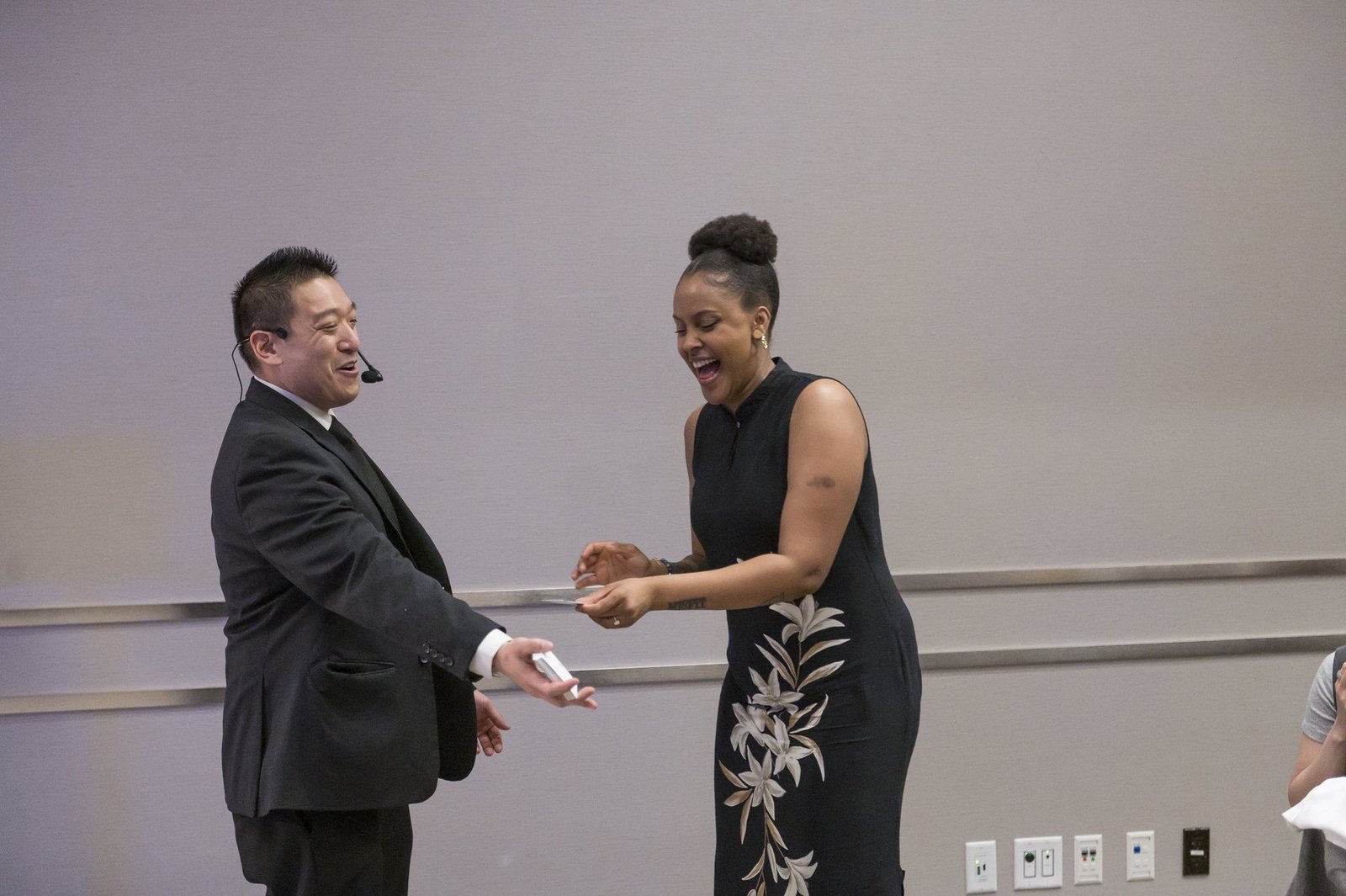 John Ha performing close-up magic for surprised guests at a Vancouver awards night reception