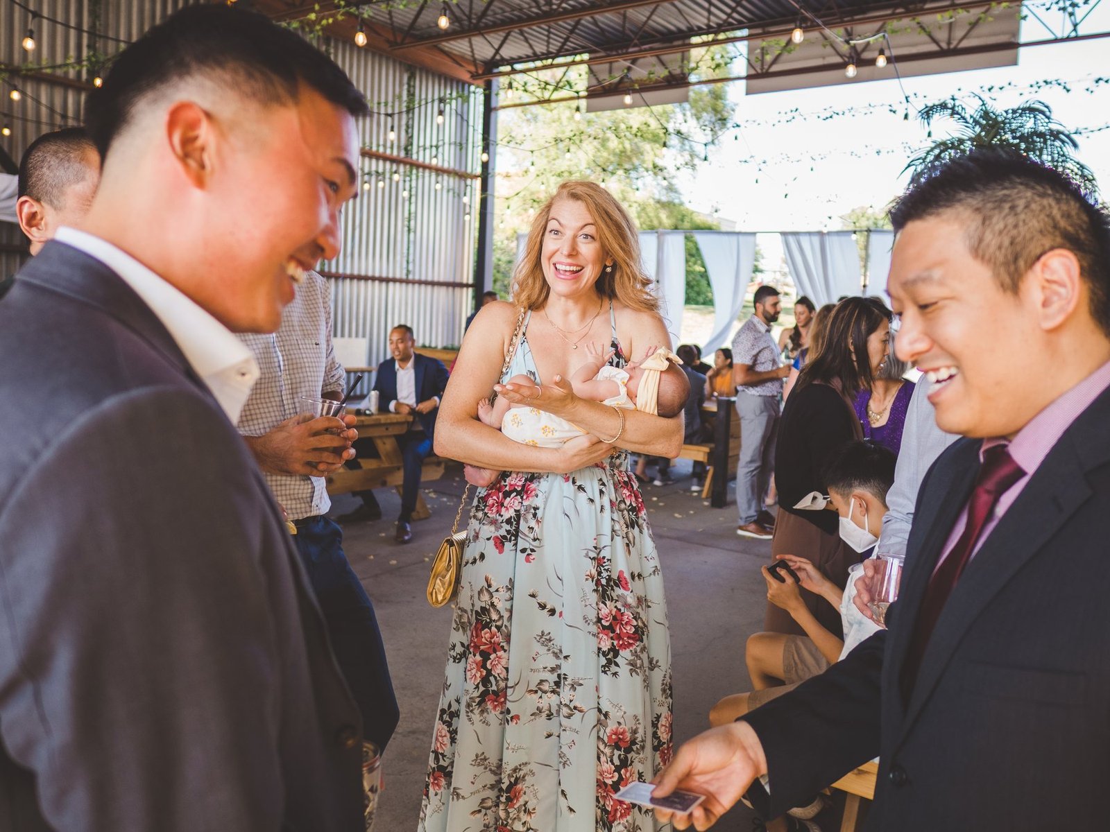John Ha performing close-up magic for laughing guests at a Vancouver banquet