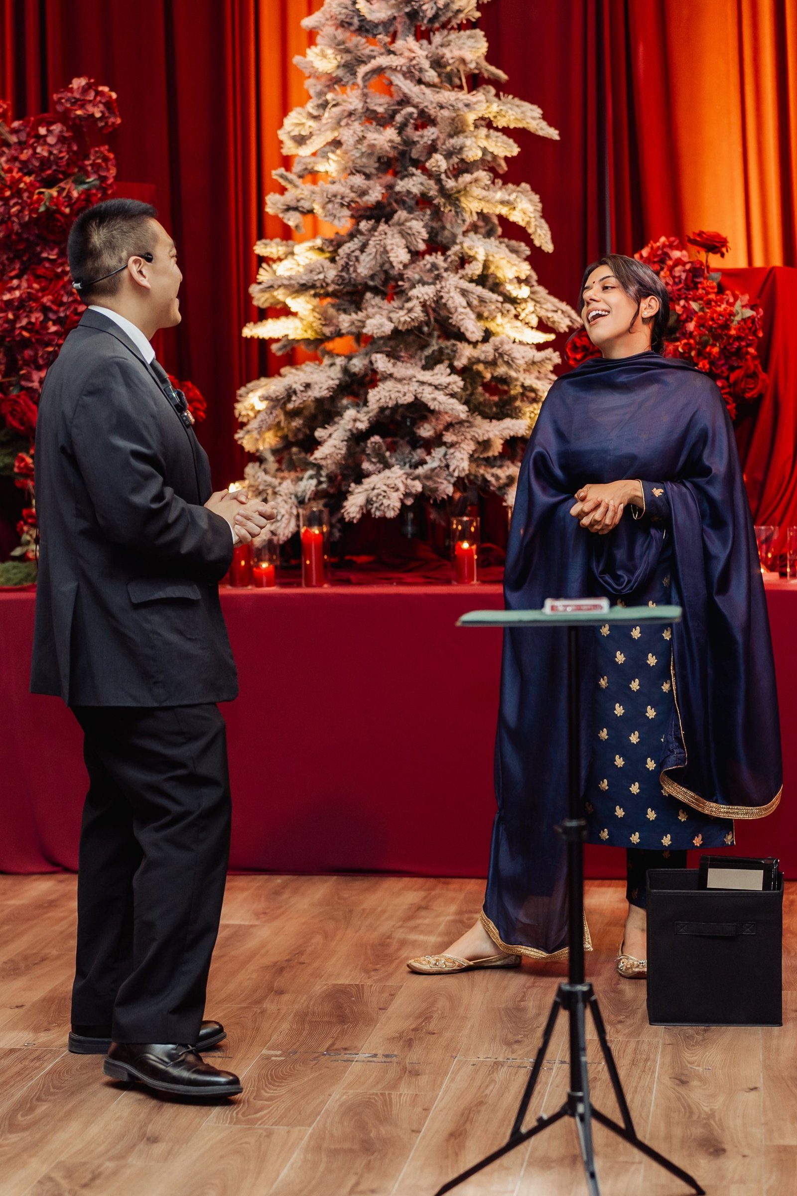 John Ha performing close-up magic for surprised guests at a Vancouver corporate party