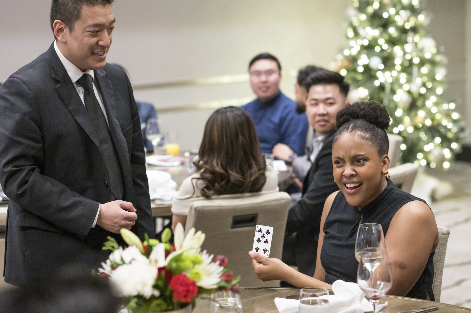 John Ha performing close-up magic for a delighted guest at a Vancouver donor appreciation style dinner