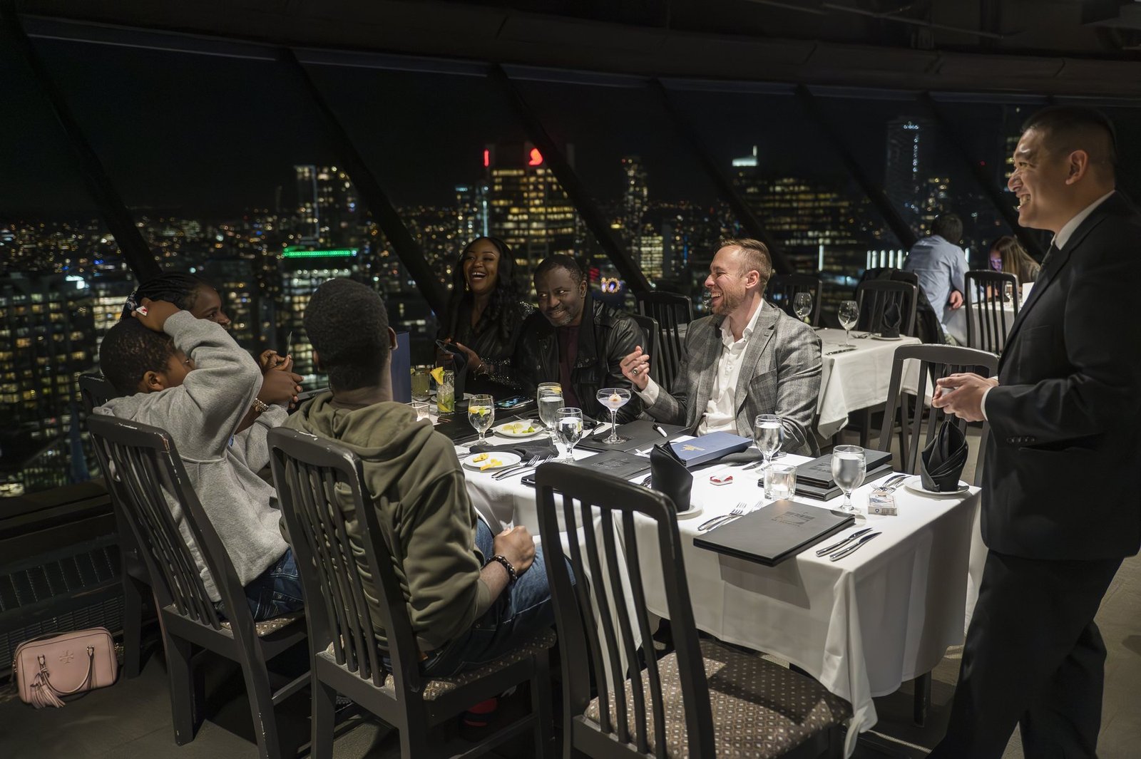 John Ha performing close-up magic for guests during an upscale Vancouver executive dinner