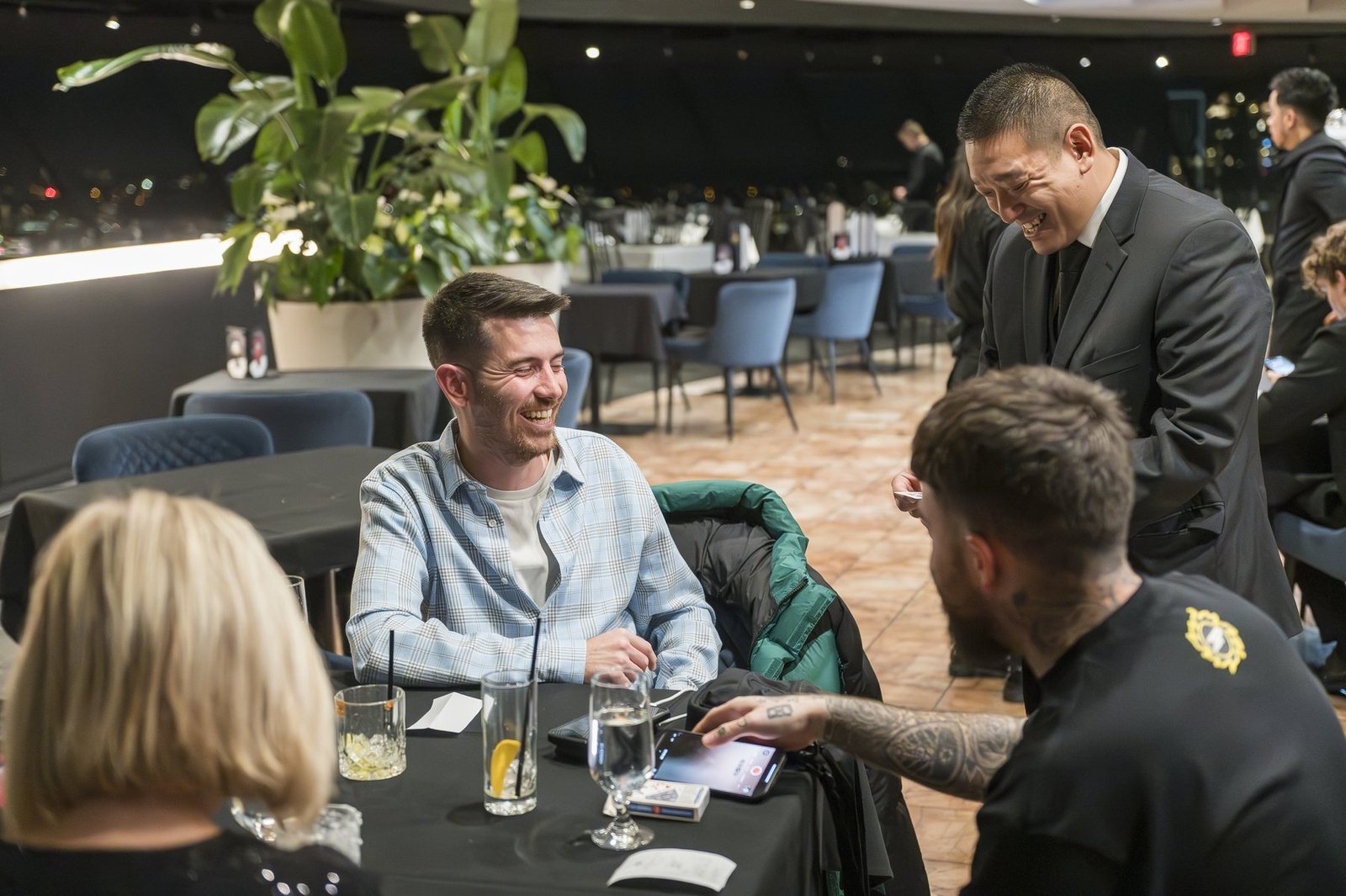 Corporate guests cheering during an interactive holiday party magic show
