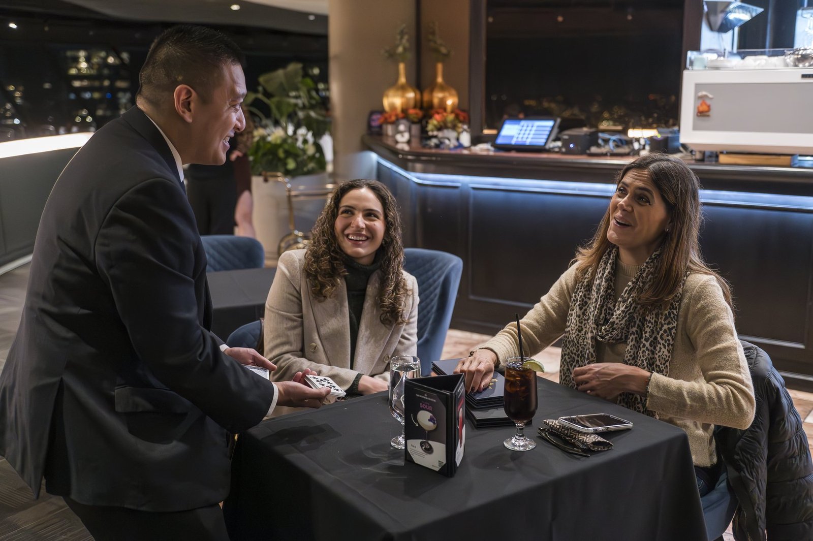 Corporate guests gathered around close-up magic at a Vancouver event
