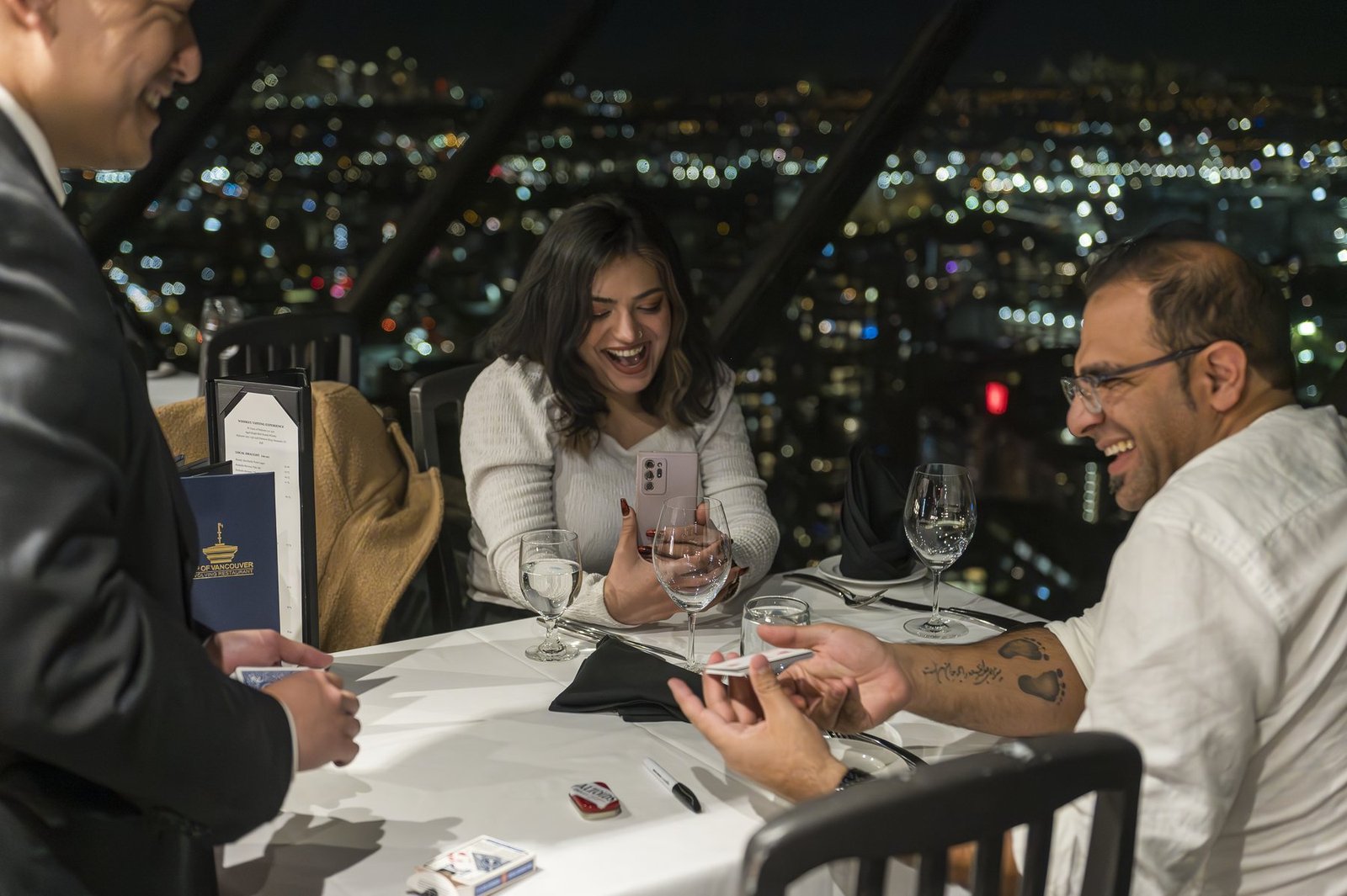 John Ha performing close-up magic for guests during an upscale private dinner in Vancouver