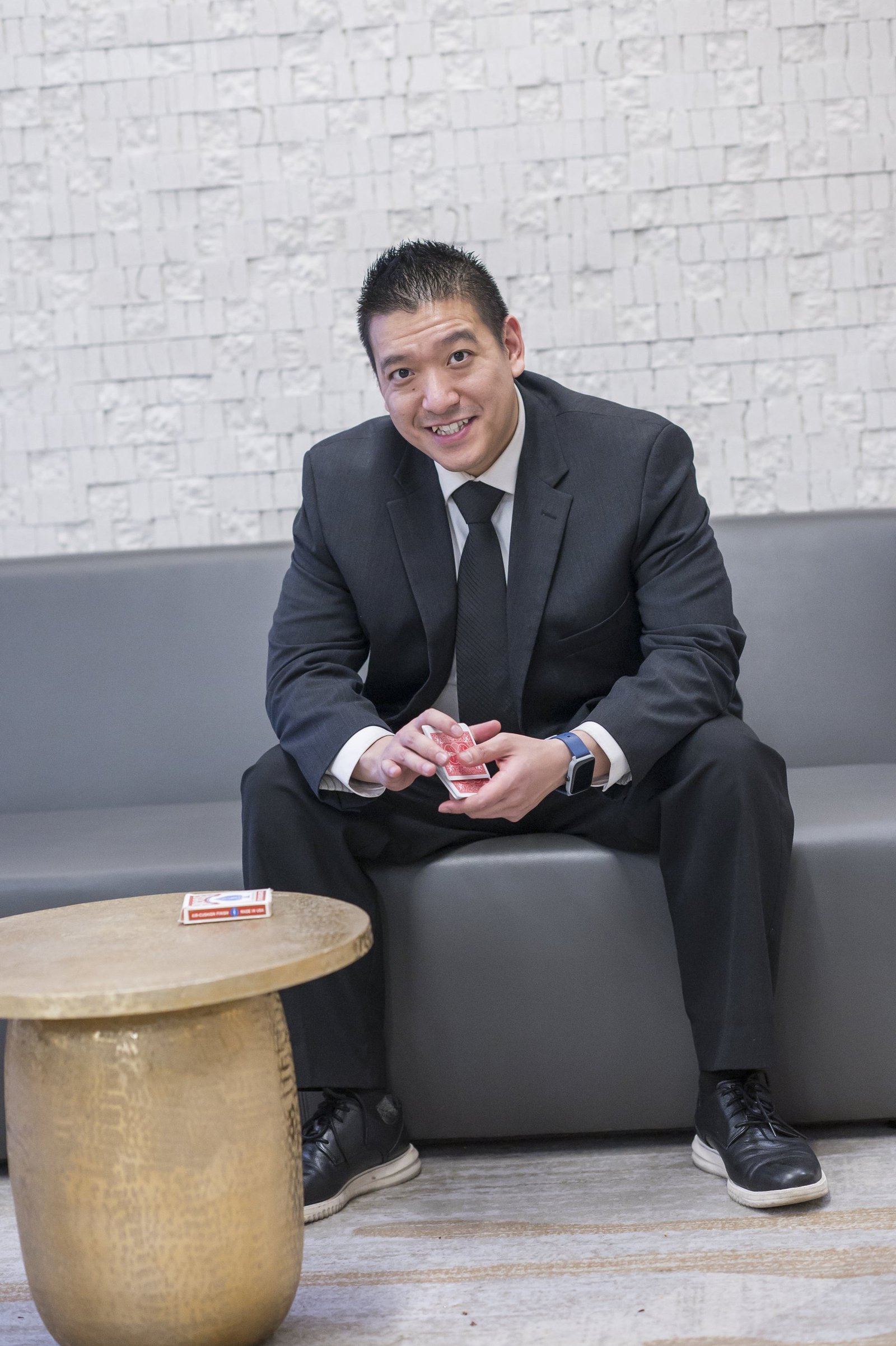 John Ha performing close-up magic for guests gathered at a private Vancouver dinner table