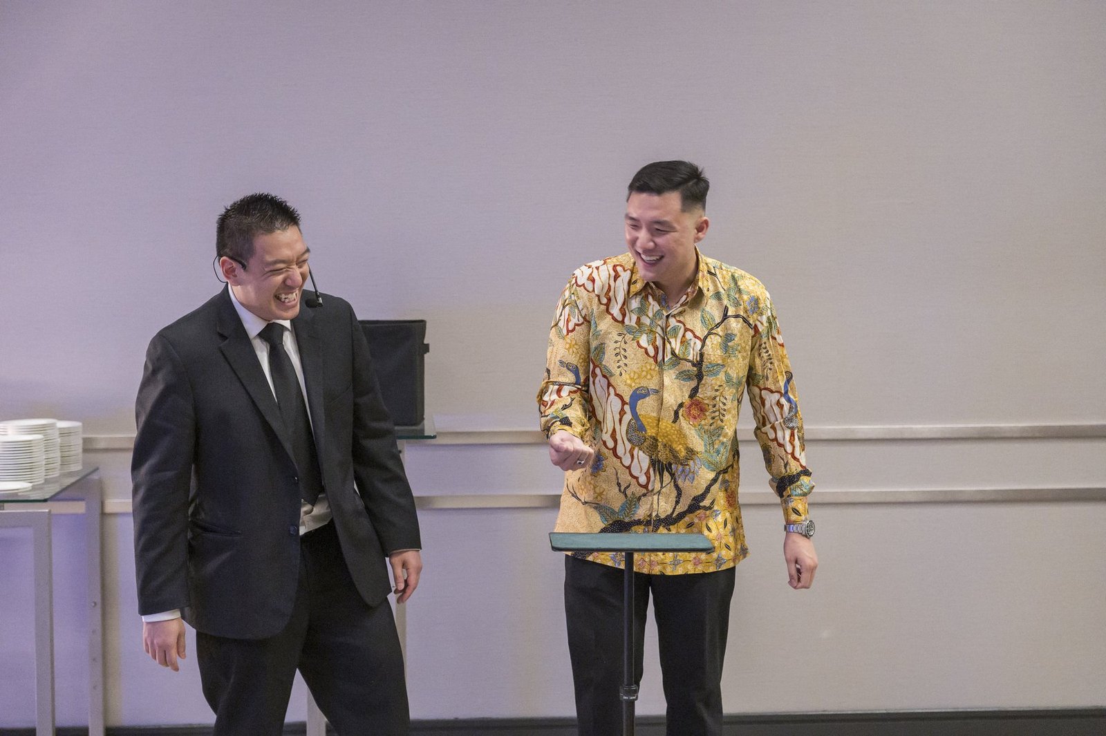 John Ha performing close-up roaming magic for laughing guests at a Vancouver event