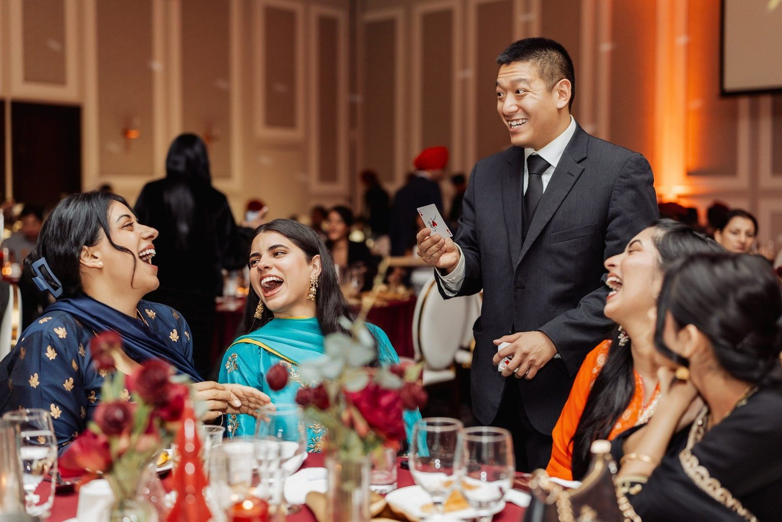 John Ha performing close-up magic for guests during a Vancouver event walkthrough style reception