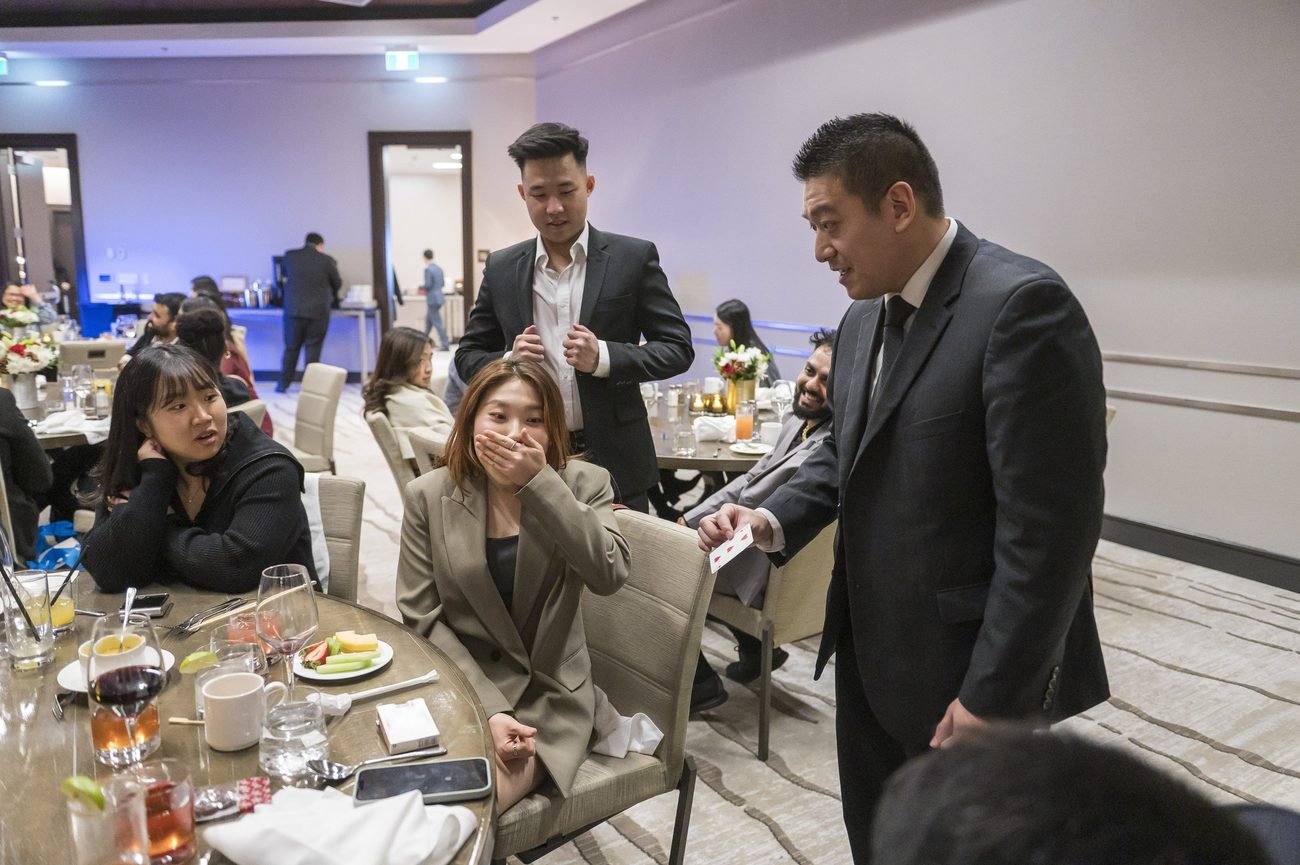 John performing close-up magic during a dinner event