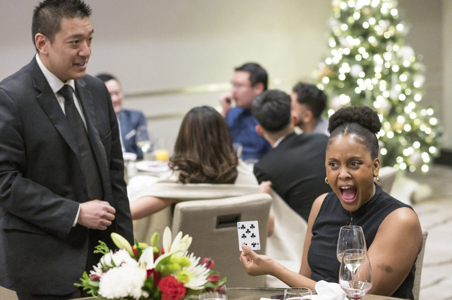 A guest reacting with amazement during John Ha's close-up magic